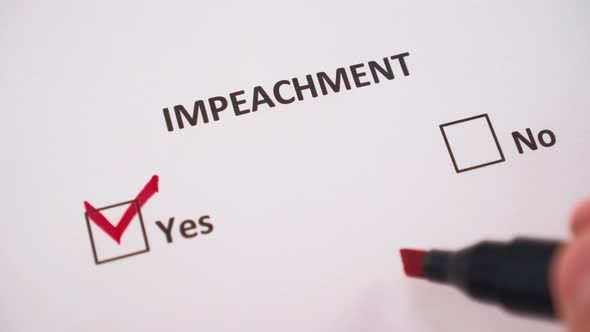 The hand ticks the word YES under the word IMPEACHMENT 