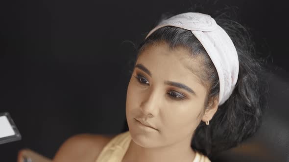 Close up of beautiful young woman in cosmetics studio with make up on her face