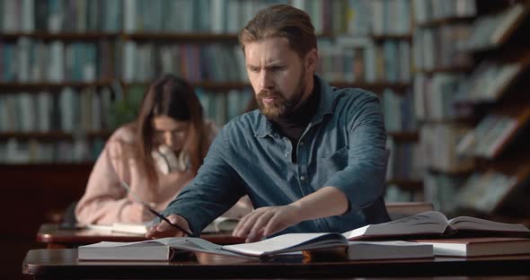 Bearded Man Studying in Library