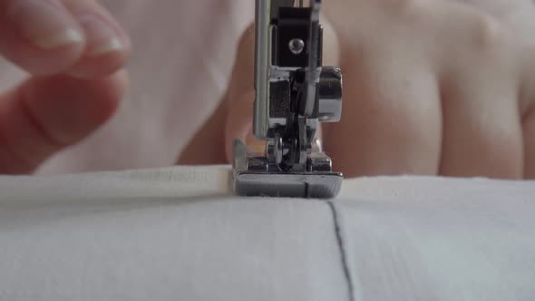 Sewing machine with fabric and thread, closeup.