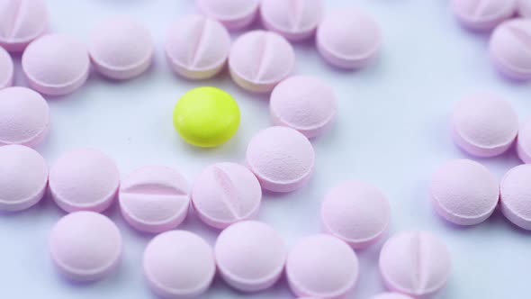 Pink Pills Neatly Folded on a White Table and Rotate Close Up