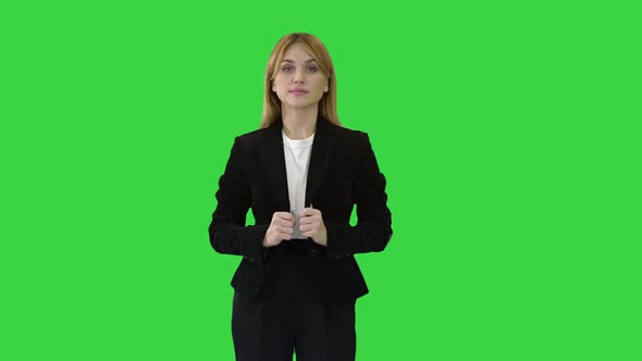Pretty Blonde Woman Standing with Arms Crossed on a Green Screen, Chroma Key.