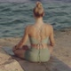Blond Young Caucasian Girl Meditation Practice on a Rock in Front of the Sea or Ocean - VideoHive Item for Sale