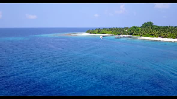 Aerial top down sky of perfect coastline beach wildlife by blue green lagoon with white sandy backgr