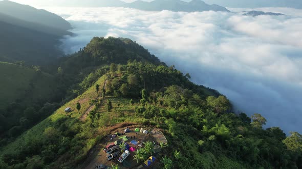 Aerial landscape view of campsite on mountain peak and the sea of fog by drone