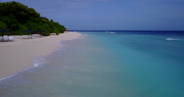 Beautiful birds eye island view of a sandy white paradise beach and aqua blue water background