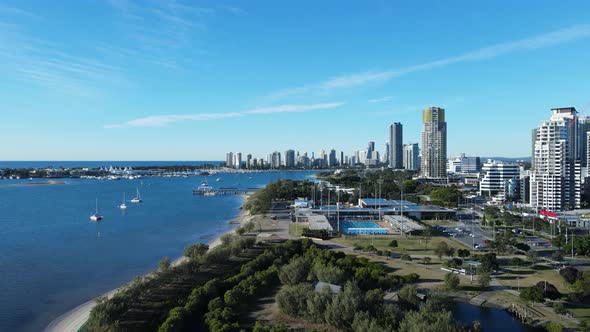 Moving drone view of a coastal rehabilitation area near a busy urban city landscape. Panoramic drone