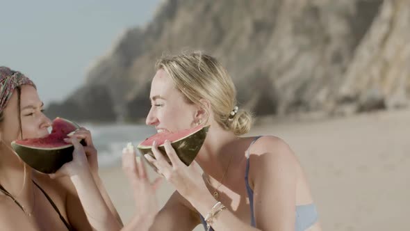 Front View of Friends Having Fun and Eating Watermelon on Beach