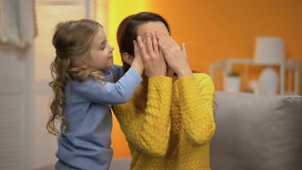 Adorable Little Girl Closing Mothers Eyes With Hands, Happy Family Moments
