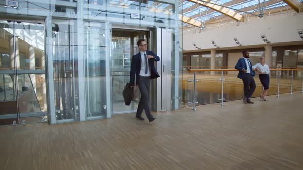 Happy Cheerful Businessman Leaving Elevator and Dancing in Office Building