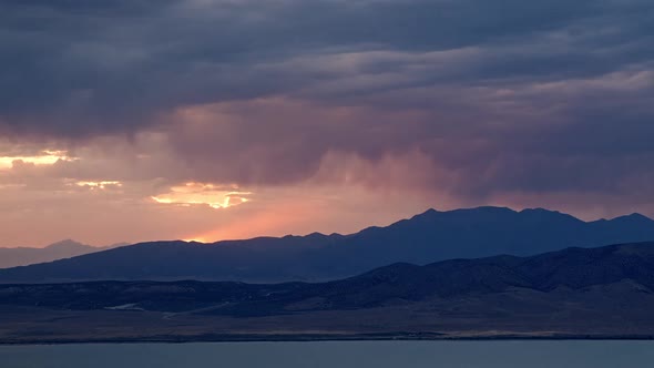Sunset timelapse as rainstorm moves over the mountains