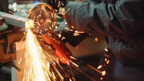 Angle Grinder Cutting Metal at Workshop