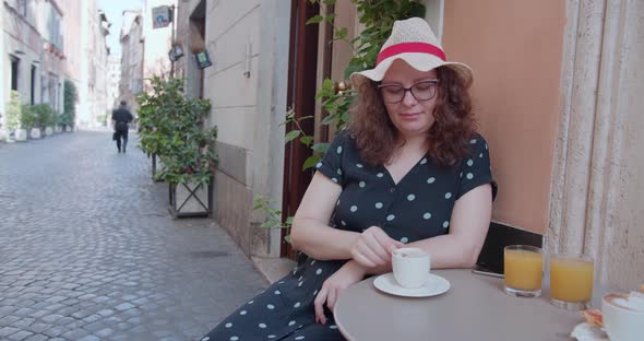 Stylish good looking woman sitting on the summer terrace