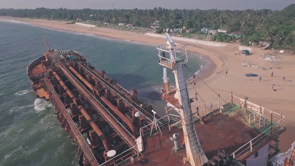 Shipwreck on a beach near Varkala in Kerala, India. Low aerial drone