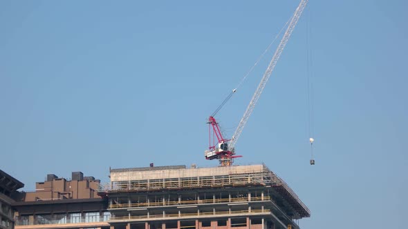 Construction Crane Carrying Block on the Top of the Building