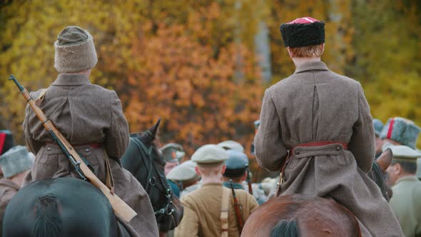 A Military Reconstruction - an Area Surrounded By Soldiers - Men Standing on the Horses on the Field