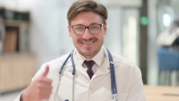 Portrait of Positive Male Doctor with Thumbs Up Sign