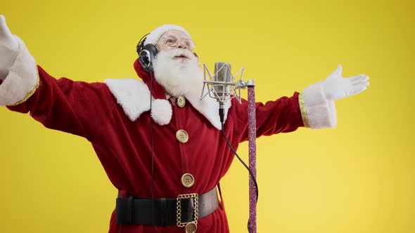 Santa Claus singing or speaking in a studio microphone. Merry Christmas.