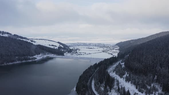 White winter wonderland of the Frumoasa dam in Romania -aerial