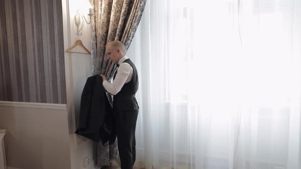 Handsome Stylish Groom Man Wearing Green Jacket at Home in Living Room Slow Motion Indoors Portrait