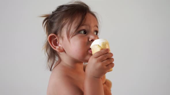 Child Toddler Girl with Ice Cream at Home. Tasty Yummy Sweet Food. Funny Face