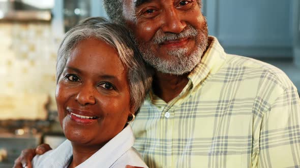 Senior couple standing in kitchen