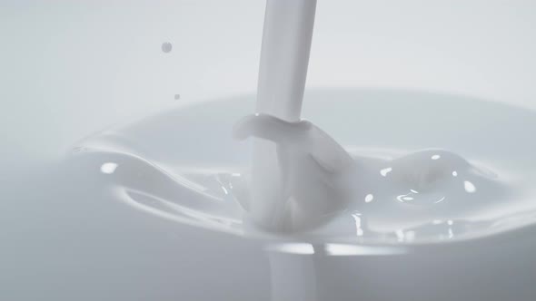 Pouring milk and making splash. Slow Motion. alt
