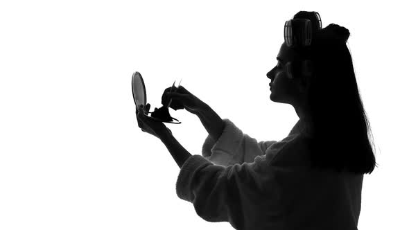 Young Woman Looking in Mirror and Applying Makeup, Preparing for Date, Beauty