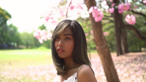 Young Beautiful Woman Looking Away in Park
