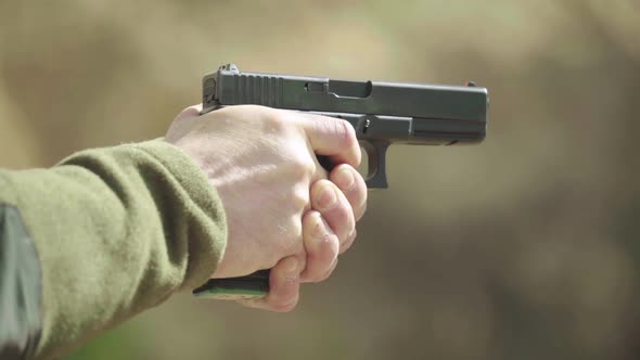 Close-up Shot of a Pistol. Slow Motion.