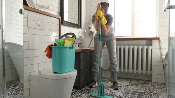 Woman is Tired to Cleaning Tile in Toilet