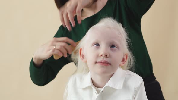 Young Cute Little Girl Model To Prepare for a Photo Shoot, She Is Doing a Hairstyle