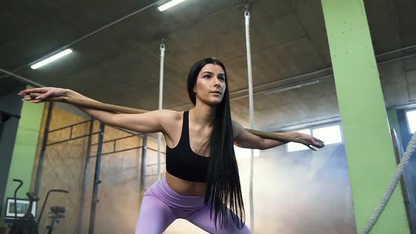 Fit Woman Doing Back Squat Cardio During Training in the Gym