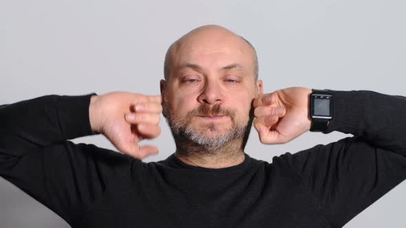 Funny and Humorous Man Who Fills His Ears with Pinkies