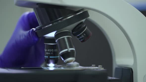 Adjusting Objective Lens of Microscope to Study Sample in Laboratory Spbd