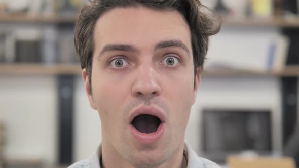 Close Up of Shocked Creative Man Wondering in Office