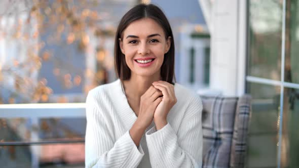 Portrait of Cozy Beauty Female Posing at Outdoor Terrace