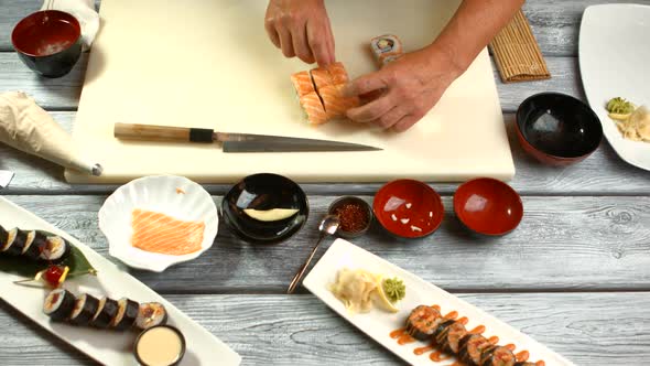 Man's Hands Touching Sushi