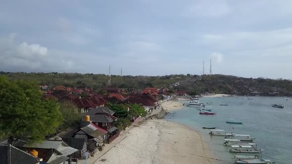 Beautiful tourist Mushroom beach on Nusa Lembongan island. Many boats, yachts and jet skis swing on