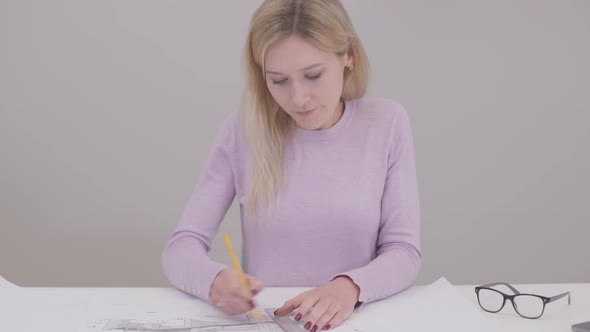 Portrait of Concentrated Caucasian Woman Drawing Blueprint, Doing Mistake and Breaking Pencil