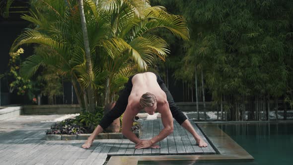 Fitness Caucasian Sporty Man Doing Yoga and Stretching Muscles