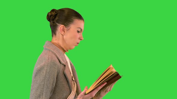 Woman Walking and Reading a Book on a Green Screen Chroma Key