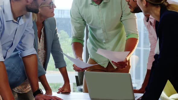 Businesspeople interacting over a document