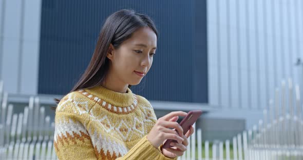 Woman use of smart phone in city