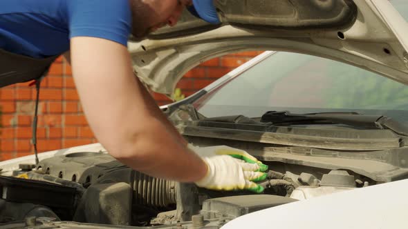 Man in Gloves Checks Satisfactory State of Car Air Filter