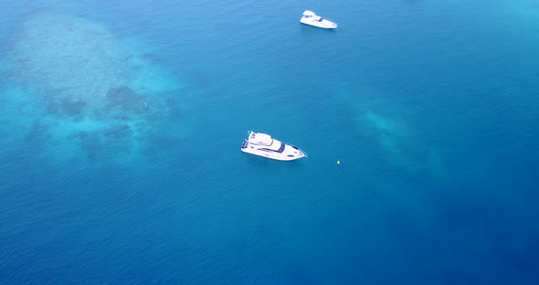 Luxury flying copy space shot of a paradise sunny white sand beach and aqua blue ocean background in