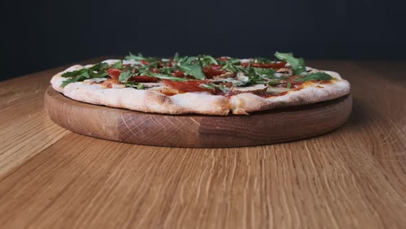 Appetizing Pizza on a Wooden Board in a Restaurant