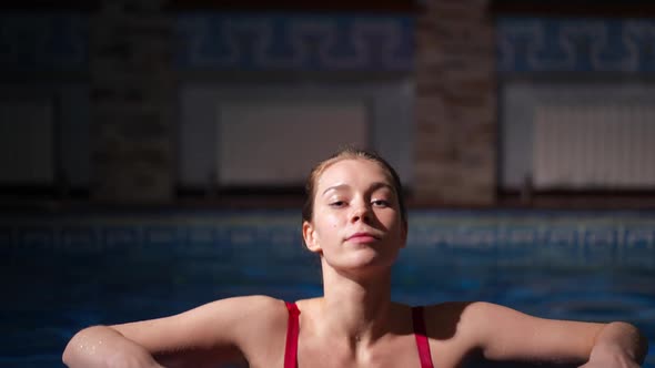 Slim Gorgeous Woman Emerging From Pool in Red Bikini Bra in Slow Motion