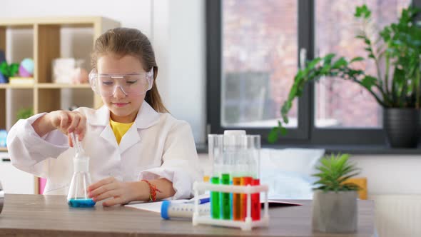 Girl with Test Tubes Studying Chemistry at Home