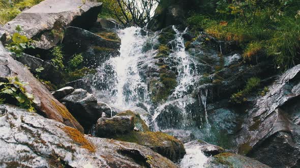 Wild Mountain Waterfall. Rapid Falling Water Hitting on Stones. Slow Motion 120